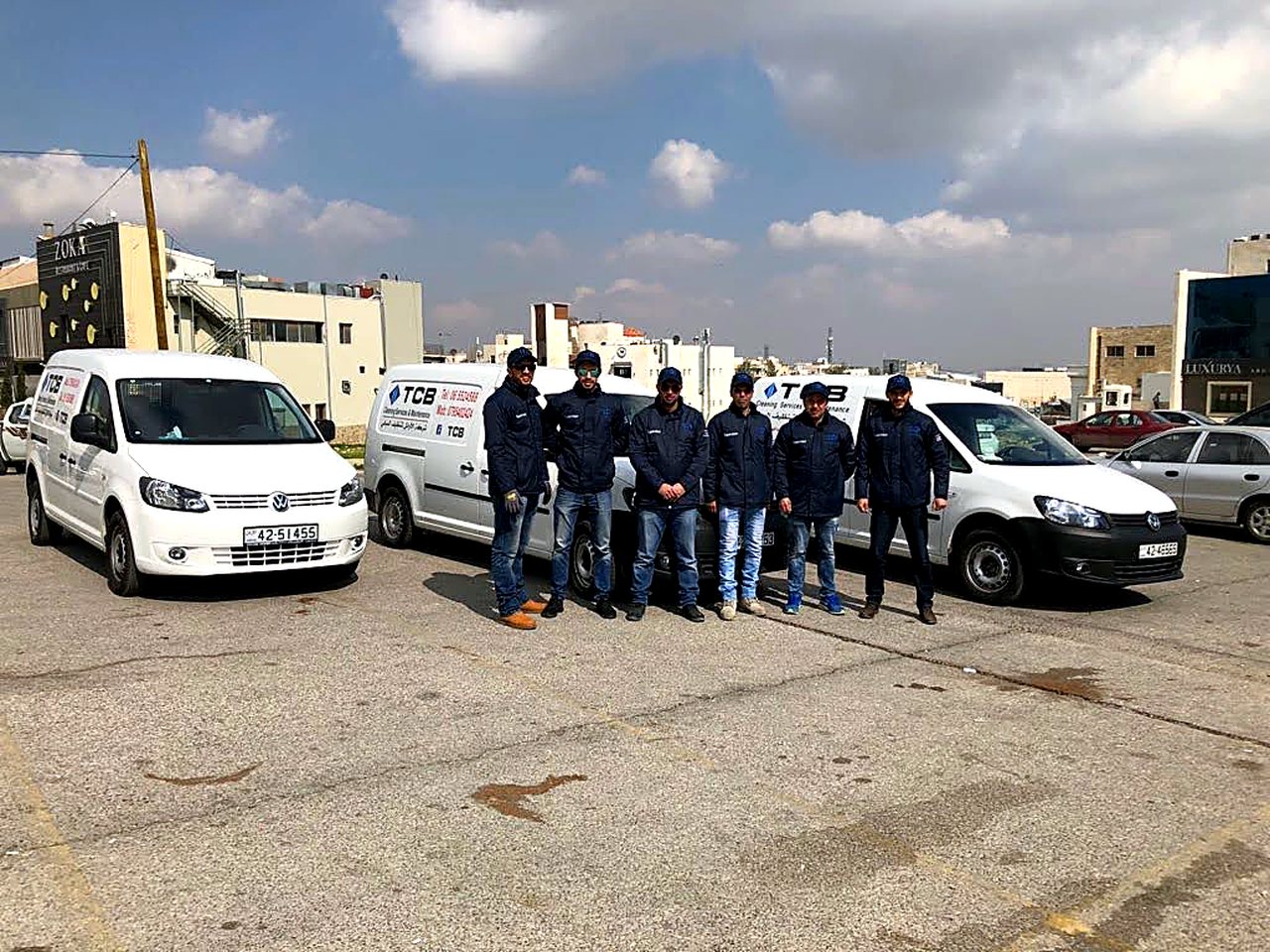فريق شركة الأوائل وسيارات الخدمة أمام أحد المواقع